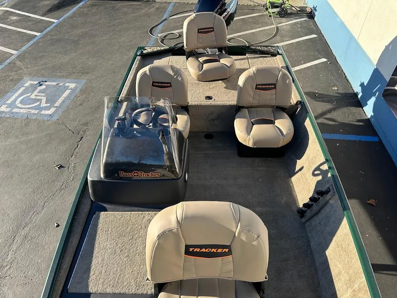 Slide: The Image of 2025 Tracker Bass Tracker Classic Limited boat with beige seating in a parking lot. - 22