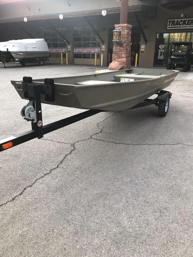 Slide: The Image of 2025 Tracker Grizzly 1542 Utility boat on trailer, parked outside dealership. - 3