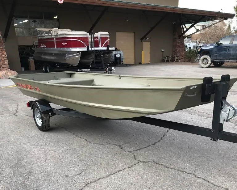 Slide: The Image of 2025 Tracker Grizzly 1542 Utility boat on trailer, parked outside a building. - 5