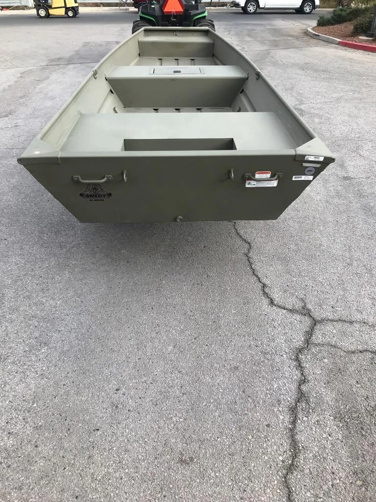 Slide: The Image of 2025 Tracker Grizzly 1542 Utility boat on pavement, rear view. - 6