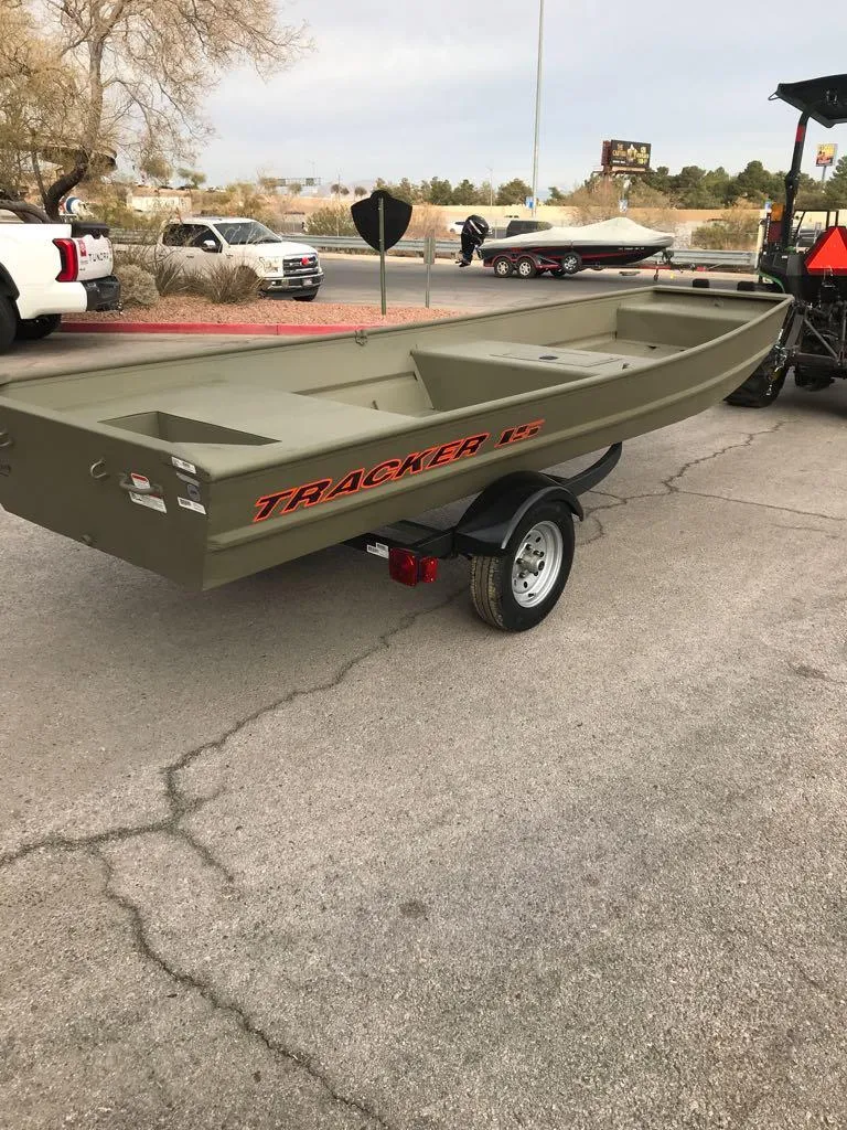 Slide: The Image of 2025 Tracker Grizzly 1542 Utility boat on trailer in parking lot. - 8