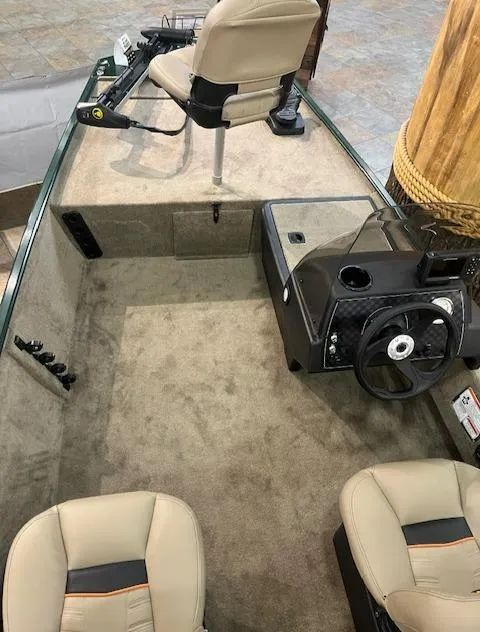 Slide: The Image of 2025 Tracker Bass Tracker Classic Limited boat interior with beige seating and steering console. - 4