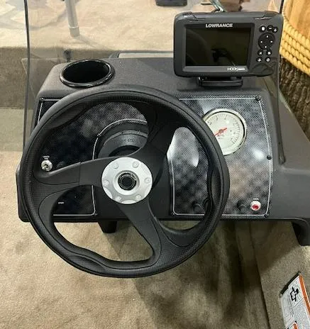 Slide: The Image of 2025 Tracker Bass Tracker Classic Limited dashboard with steering wheel and Lowrance fishfinder. - 7