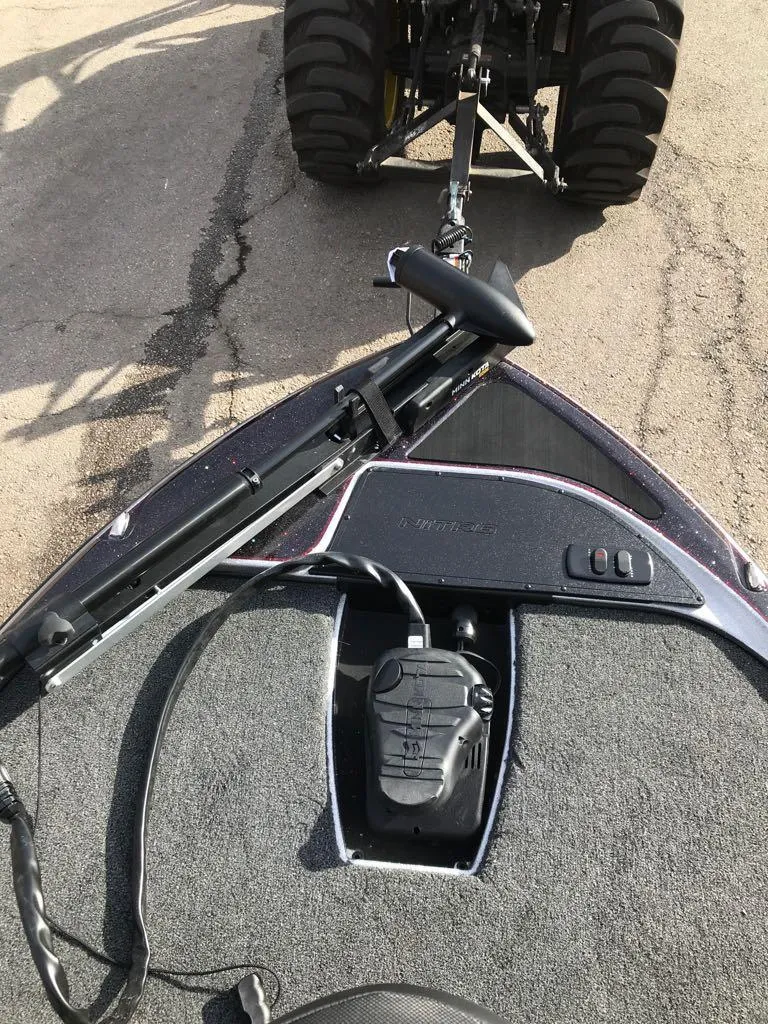 Slide: The Image of 2025 Nitro Z17 boat with trolling motor, hitched to a vehicle on a paved road. - 20