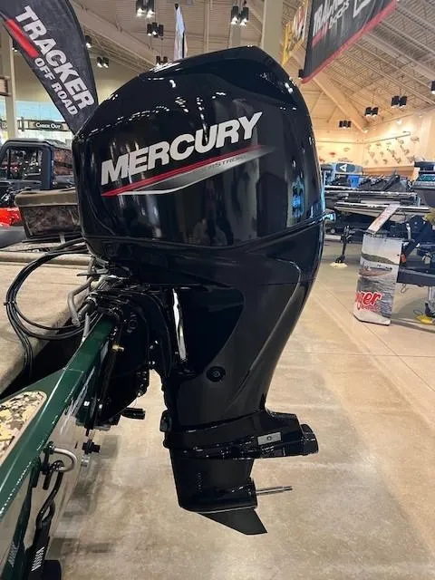 Slide: The Image of 2025 Tracker Bass Tracker Classic Limited with Mercury outboard motor in showroom. - 4