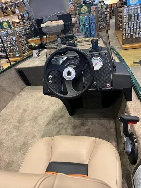 Slide: The Image of 2025 Tracker Bass Tracker Classic Limited boat interior with steering wheel and dashboard. - 5