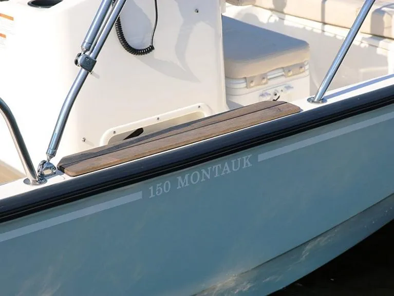 Slide: The Image of 2025 Boston Whaler 150 Montauk boat detail with seating and railing. - 16