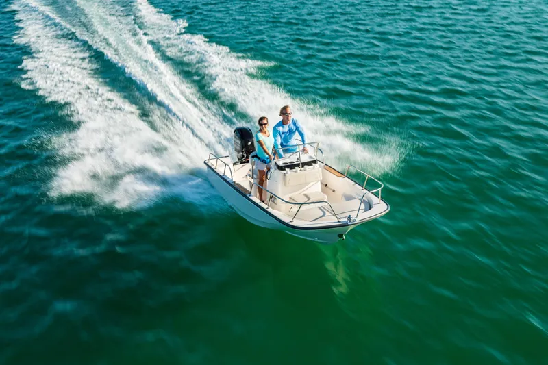 Slide: The Image of 2025 Boston Whaler 150 Montauk cruising on open water. - 19