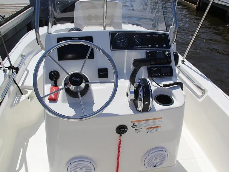Slide: The Image of 2025 Boston Whaler 150 Montauk boat console with steering wheel and controls. - 21