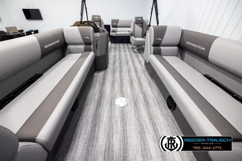 Slide: The Image of 2025 Bennington 23 SSBSE pontoon boat interior with gray seating and carpeted flooring. - 13