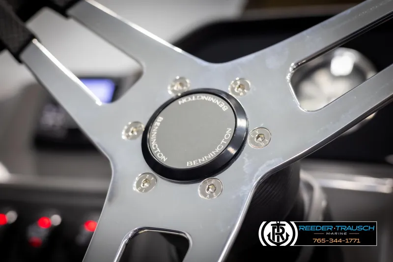 Slide: The Image of Steering wheel of 2025 Bennington 23 SSBSE boat, featuring sleek metallic design. - 29