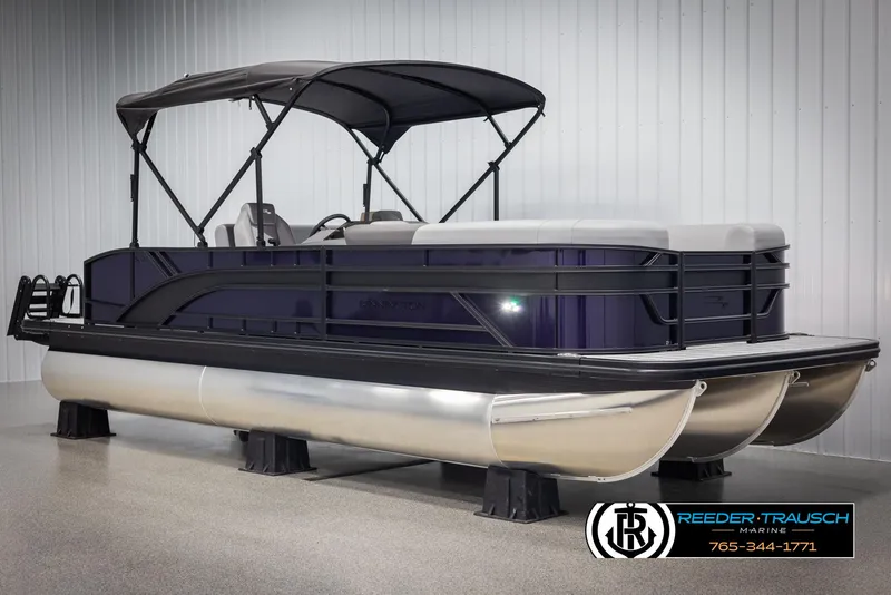 Slide: The Image of 2025 Bennington 23 SSBSE pontoon boat with canopy, displayed indoors. - 3