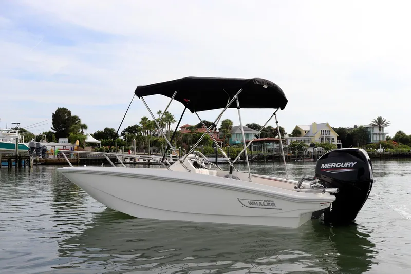Slide: The Image of 2024 Boston Whaler 160 Super Sport boat on calm water with Mercury engine. - 19