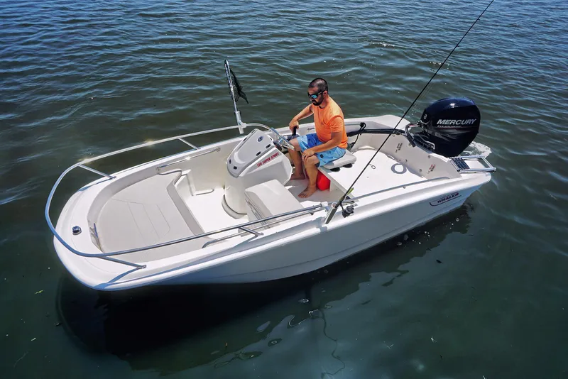 Slide: The Image of 2024 Boston Whaler 160 Super Sport boat on water, man steering. - 23