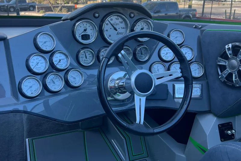 Slide: The Image of Dashboard of 2015 Daves Custom Boats M-29 with multiple gauges and steering wheel. - 13