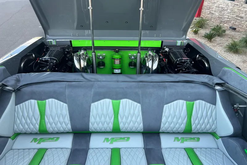 Slide: The Image of 2015 Daves Custom Boats M-29 interior with green and gray seating and open engine compartment. - 14