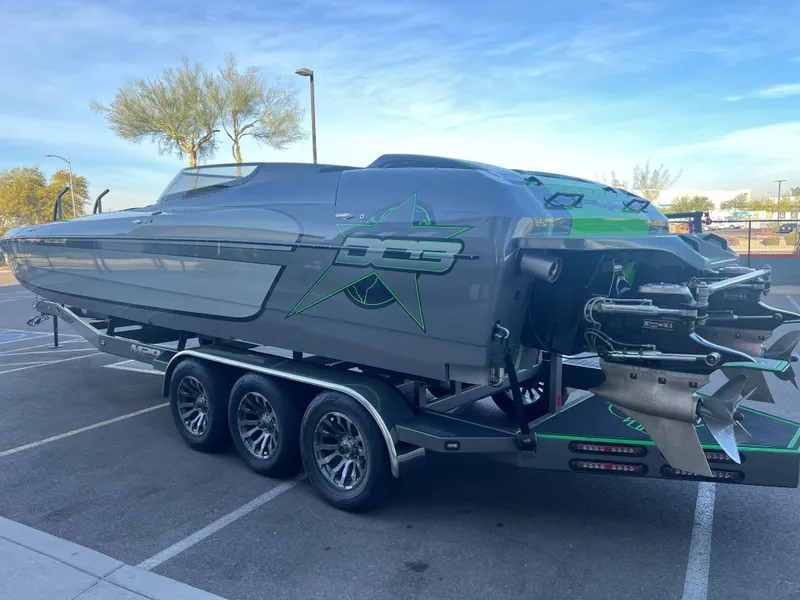 Slide: The Image of 2015 Daves Custom Boats M-29 on trailer, sleek design, parked outdoors. - 3