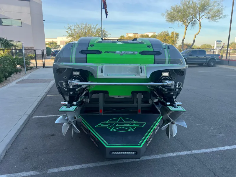Slide: The Image of 2015 Daves Custom Boats M-29, green and black, parked in a lot, rear view. - 4