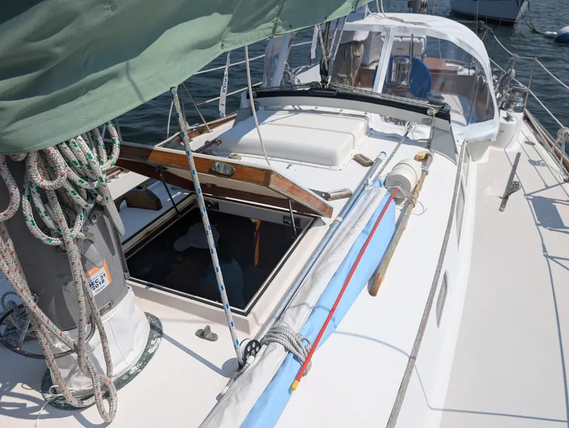 Slide: The Image of Hinckley Bermuda 40 Yawl 1974 sailboat deck with ropes and open hatch. - 11
