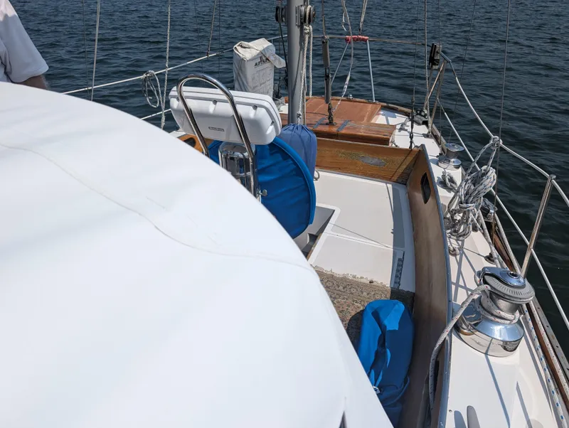 Slide: The Image of Hinckley Bermuda 40 Yawl 1974 sailboat deck with blue covers and winches on a sunny day. - 13