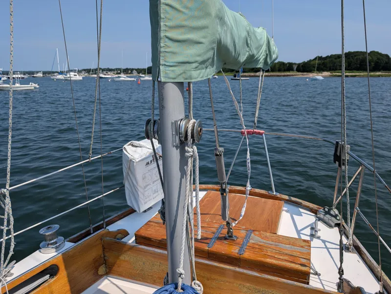 Slide: The Image of 1974 Hinckley Bermuda 40 Yawl sailboat on calm waters, featuring wooden deck and rigging. - 14