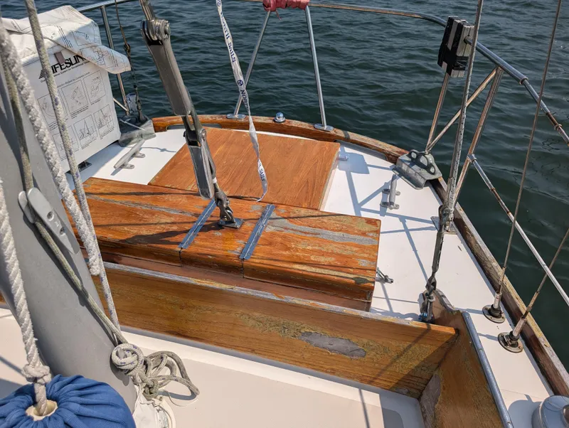 Slide: The Image of Hinckley Bermuda 40 Yawl 1974, wooden deck details, sailing on calm waters. - 15