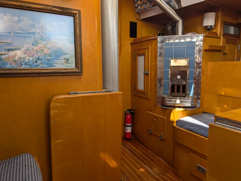 Slide: The Image of Interior of 1974 Hinckley Bermuda 40 Yawl with wood paneling and nautical decor. - 26