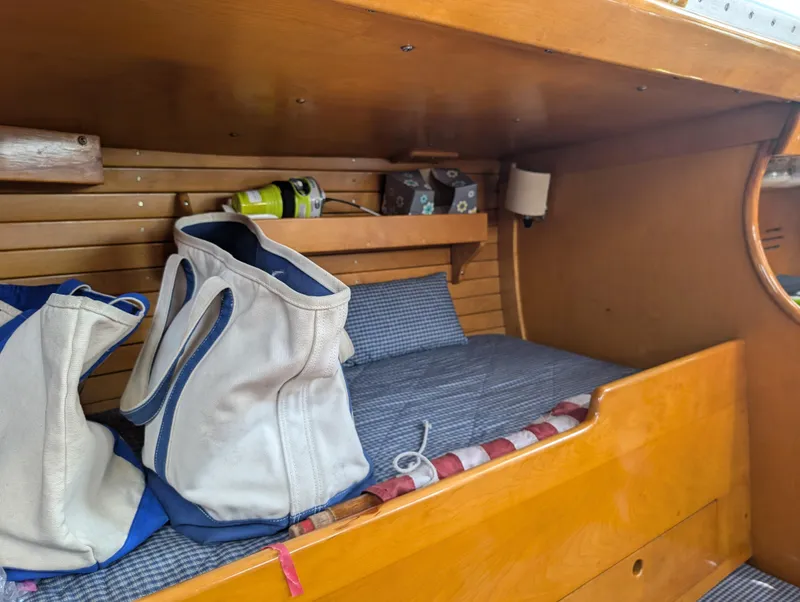 Slide: The Image of Interior cabin of 1974 Hinckley Bermuda 40 Yawl with wooden finish and storage bags. - 28