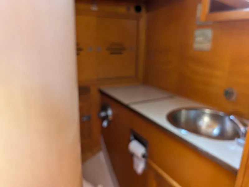 Slide: The Image of 1974 Hinckley Bermuda 40 Yawl interior with sink and wooden cabinetry. - 29