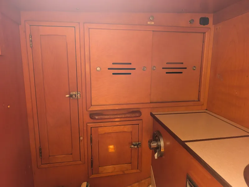 Slide: The Image of 1974 Hinckley Bermuda 40 Yawl interior with wooden cabinetry and storage compartments. - 31