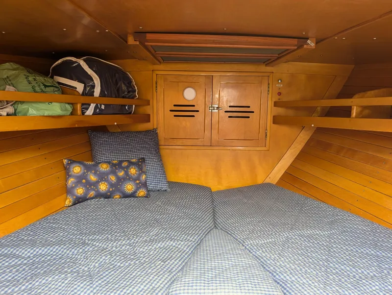 Slide: The Image of Cozy cabin interior of 1974 Hinckley Bermuda 40 Yawl with wooden finish and bedding. - 34