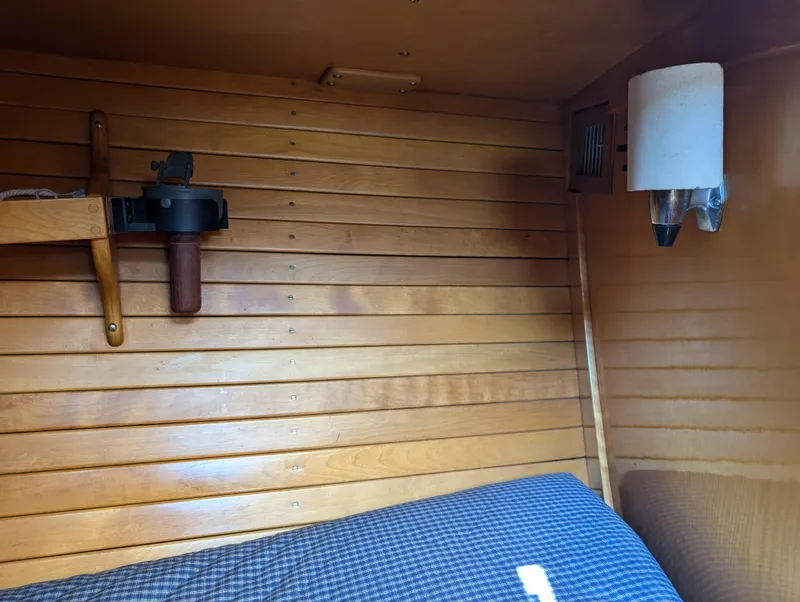 Slide: The Image of Interior of 1974 Hinckley Bermuda 40 Yawl with wooden paneling and cozy bedding. - 36
