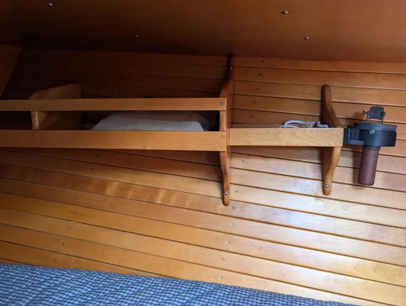 Slide: The Image of Interior of 1974 Hinckley Bermuda 40 Yawl with wooden paneling and storage shelves. - 37