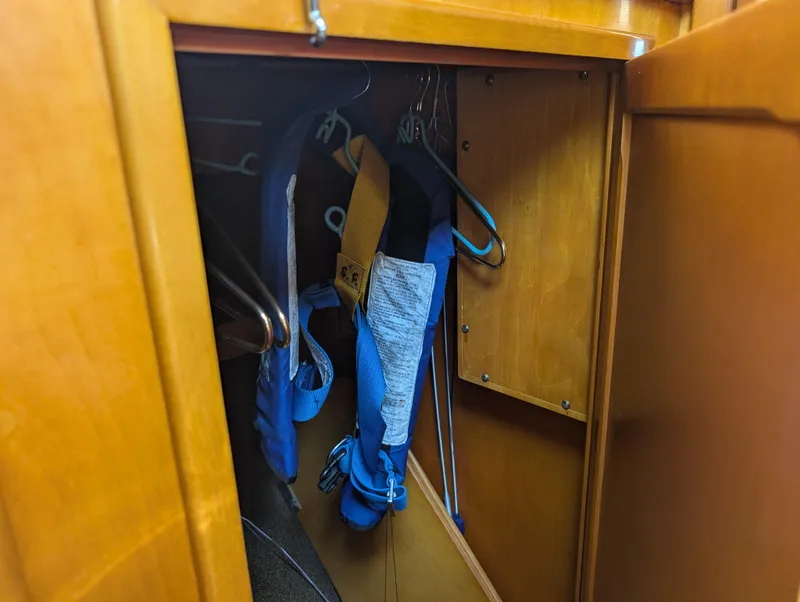 Slide: The Image of Wooden closet interior on 1974 Hinckley Bermuda 40 Yawl, with clothes and hangers. - 38
