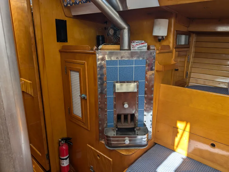 Slide: The Image of 1974 Hinckley Bermuda 40 Yawl interior with wood paneling and stove. - 47