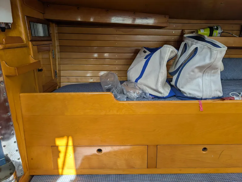 Slide: The Image of Interior of 1974 Hinckley Bermuda 40 Yawl with wooden paneling and storage bags. - 48