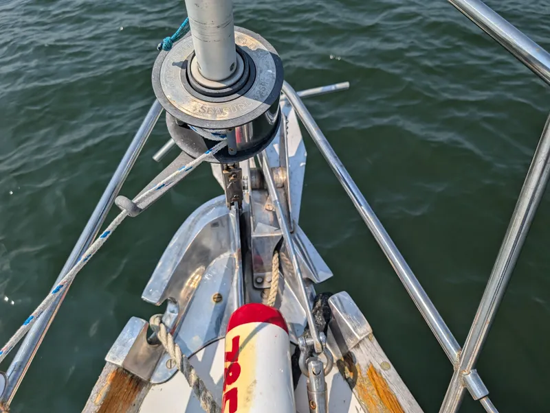 Slide: The Image of Hinckley Bermuda 40 Yawl 1974 bow with anchor and rigging over water. - 6