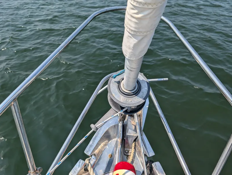Slide: The Image of Hinckley Bermuda 40 Yawl 1974 bow with sail furler over water. - 7