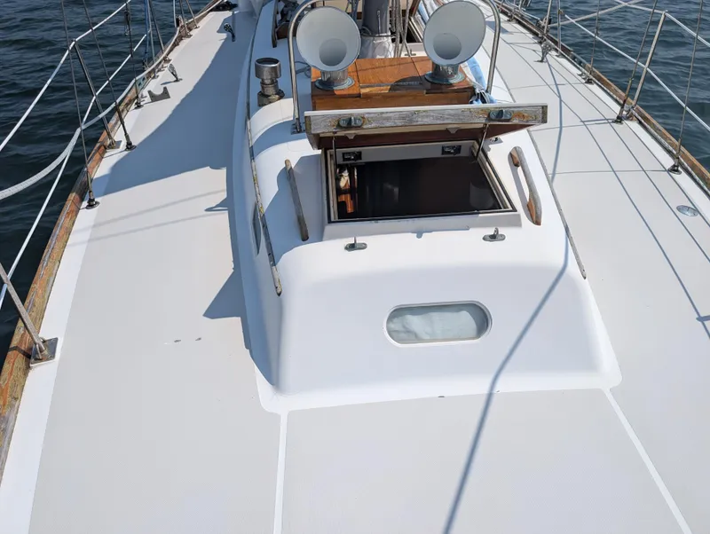 Slide: The Image of 1974 Hinckley Bermuda 40 Yawl deck view with open hatch and railing. - 8
