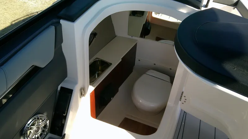 Slide: The Image of 2025 Chaparral 2870 SSX boat interior with compact bathroom and sink. - 10