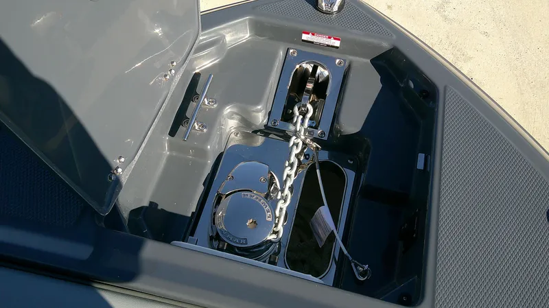 Slide: The Image of Anchor compartment of 2025 Chaparral 2870 SSX boat, featuring chain and winch. - 12