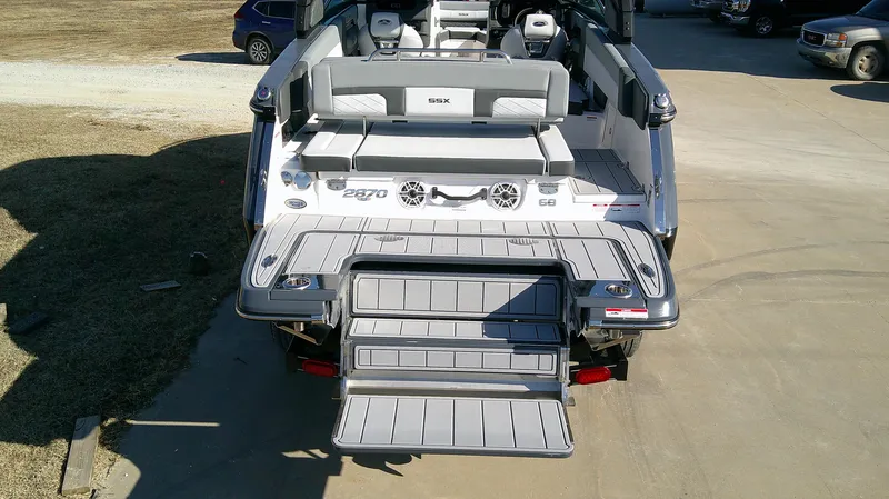 Slide: The Image of 2025 Chaparral 2870 SSX boat with extended swim platform and seating area. - 4