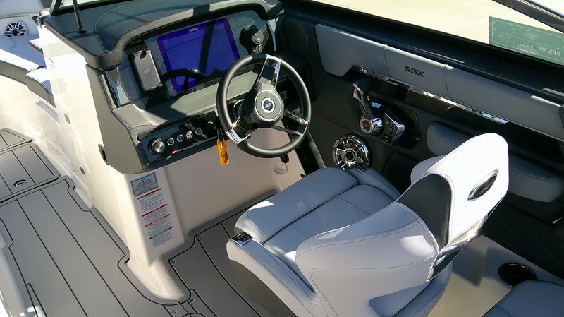 Slide: The Image of 2025 Chaparral 2870 SSX boat interior with modern dashboard and steering wheel. - 7