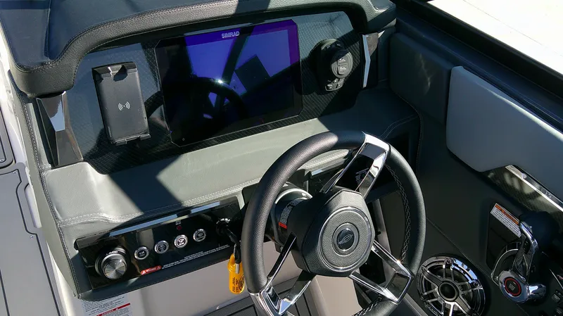 Slide: The Image of 2025 Chaparral 2870 SSX boat dashboard with steering wheel and digital display. - 8