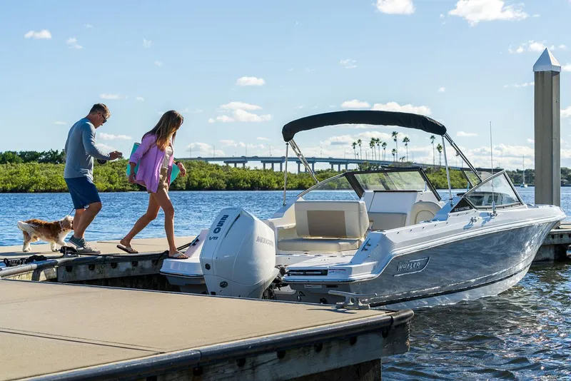 Slide: The Image of Couple and dog boarding 2024 Boston Whaler 210 Vantage at dock. - 6