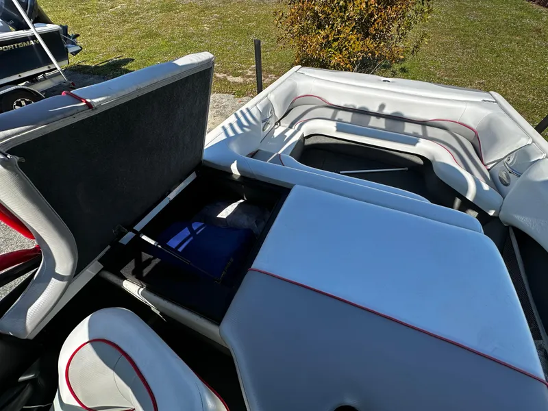 Slide: The Image of 2002 Malibu Wakesetter XTi interior with open storage compartments and white upholstery. - 14