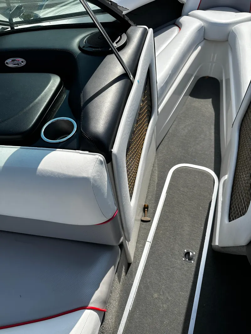 Slide: The Image of Interior of 2002 Malibu Wakesetter XTi boat with white seating and cup holder. - 20
