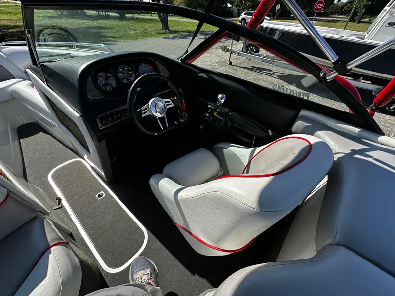 Slide: The Image of Interior of a 2002 Malibu Wakesetter XTi boat with sleek seating and dashboard. - 5