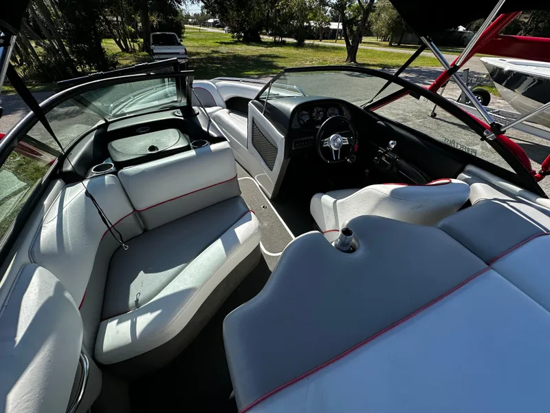 Slide: The Image of 2002 Malibu Wakesetter XTi boat interior with white seating and steering wheel. - 6