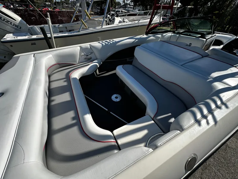 Slide: The Image of 2002 Malibu Wakesetter XTi boat interior with white seating and open deck layout. - 9
